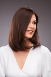 Laughing woman with hair fall wearing a brunette Gwyneth wig 