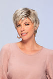 Happy woman with fine hair is covering her head in a light blonde short style Mono Simplicity wig 