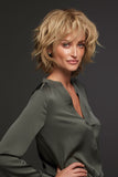 Model with complete hair loss covering her head in a blonde Sofia Human hair wig by Jon Renau 