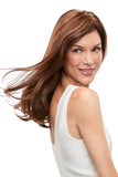 Model with thinning hair covering her hair with a long sleek Remy human hair Top Form French Topper