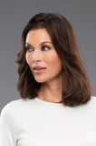 Lady wearing short brown clip in hair extensions that measure 8 inches long by 4 inches wide