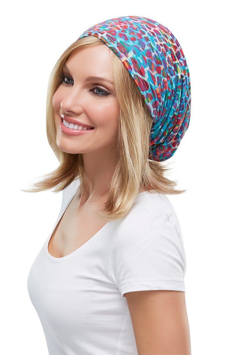 Happy woman with hair loss is wearing a Softie Boho Beanie Print 