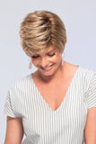 Laughing woman with thinning hair is wearing a short style Allure Petite wig 