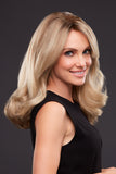 Smiling woman with Alopecia is showing her Blonde Remy human hair Angie wig 