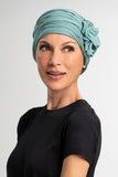 Lady with complete hair loss wearing a blue sage coloured blossom softie