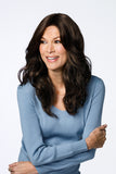 Happy woman with fine hair wearing the long wavy brunette Bryce wig from Fascinations 