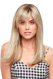 Young woman with balding wearing a light blonde Camilla wig with side-swept bangs