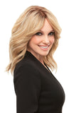 Young model with fine hair showing her blonde layered Cara wig 