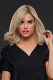 Young woman with fine hair showing her Carrie Petite human hair wig 