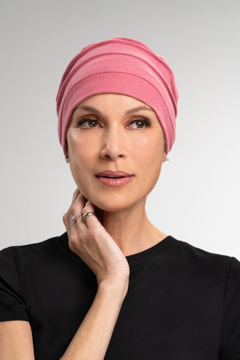 Lady with total hair loss wearing her pink Cozy hat to keep her scalp warm