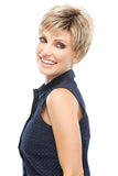 Smiling woman with hair loss wearing her blonde synthetic Elite wig 