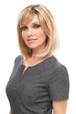 Happy woman with fine hair is showing her blonde Emilia long bob style wig 
