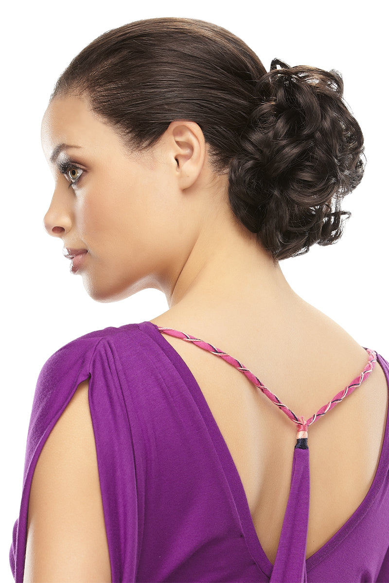 Elegant woman adding fullness to her hair by wearing the Fun Bun synthetic hairpiece 
