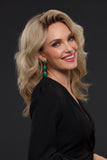 Smiling woman with thinning hair is covering her head with the Human hair Jennifer wig 