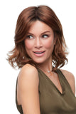 Happy woman with progressive hair loss wearing a Kendall wig with playful waves and fierce layers 