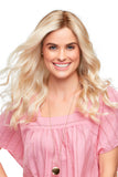 Smiling woman with hair loss showing her long blonde wavy Sarah wig 