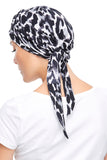 Lady with progressive hair loss wearing a black and white leopard print Softie Wrap 