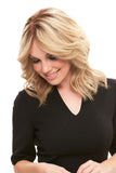 Laughing woman with hair fall is showing her light blonde Cara wig with a lace front 