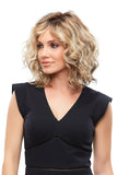 Young woman with thinning hair showing the blonde wavy synthetic Julianne Petite wig 