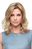 Young woman with hair loss wearing a wavy blonde Kendall wig 