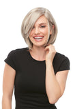 Laughing woman with fine hair wearing a blonde Kristi wig with a mono top and lace front 