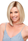 Young woman with thinning hair wearing a bob style synthetic Cameron wig in a blonde colour 