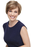 Smiling woman with hair loss wearing the short styled Mariska wig 