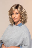 Woman with thinning hair wearing the wavy style Maya wig by Jon Renau 