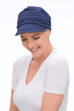 Laughing woman with thinning hair wearing a blue Softie Cap by Jon Renau Cape Town 