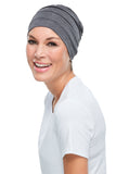 Happy woman with complete hair loss showing her grey Playful Softie from Fascinations 