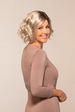 Happy woman with progressive hair loss wearing her playfully wavy Quinn wig from Fascinations 