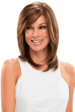 Smiling woman with thinning hair wearing a brunette Sandra wig with a single monofilament cap 