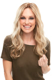 Lady with thinning hair wearing a long blonde wavy Sarah wig with Smartlace technology 