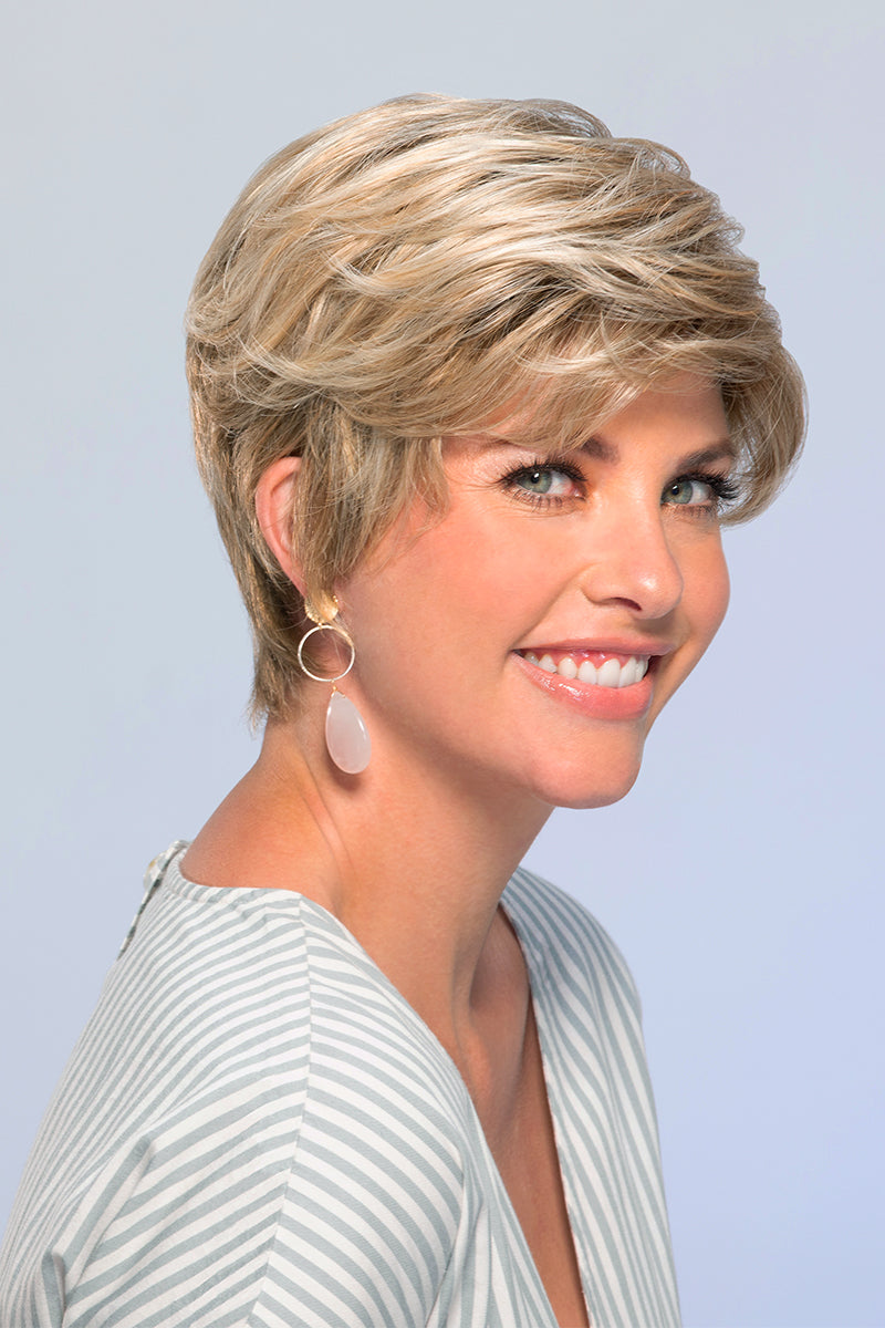 Smiling woman with fine hair is wearing a short synthetic Allure wig 