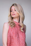Lady showing the side details of the Sienna human hair wig in Blonde