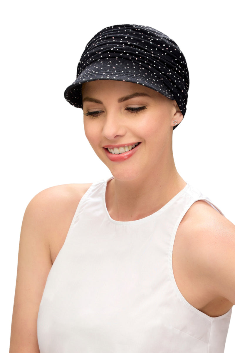 Happy woman with alopecia is wearing a Softie Cap Print in black with white dots