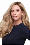 Elegantly dressed woman with long blonde hair is wearing a Top Smart Wavy hair topper in 18 Inches 