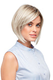 Young model with Alopecia is wearing a sleek modern bob style Victoria wig in a light blonde shade 