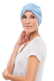 Model with hair loss is covering her head in a blue Terry Turban by Jon Renau 