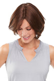 Smiling woman with beginning stage hair loss showing her 8 inch Easipart French hair topper 